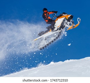 Snowmobile Jump. Extreme Snowmobile Ride & Racing. A Bright Suit And A Snow Motorcycle. Winter Recreation. High Resolution And Photo Quality