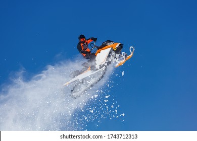 Snowmobile Jump. Extreme Snowmobile Ride & Racing. A Bright Suit And A Snow Motorcycle. Winter Recreation. High Resolution And Photo Quality