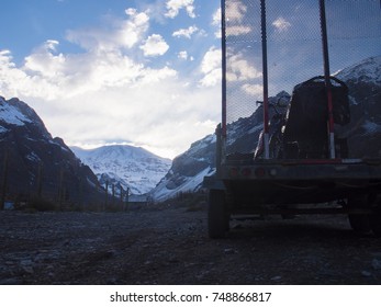 Snowmobile On Trailer In Front Of Large Andes Mountain Range In Chile