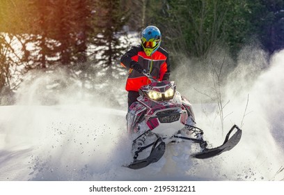 Snowmobile riding with fun in deep snow powder during backcountry tour. Extreme sport adventure, outdoor activity during winter holiday on ski mountain resort - Shutterstock ID 2195312211