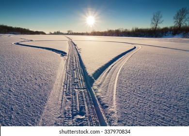 The Snowmobile Tracks In The Snow