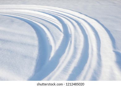 Snowmobile tracks and tire tracks in snow