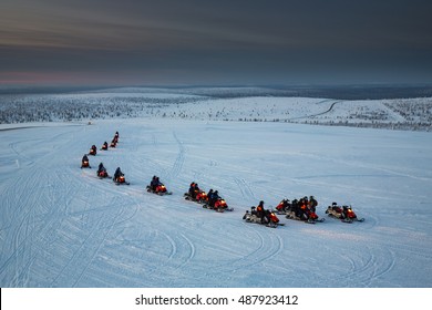 Snowmobiles In Motion. Lapland, Finland.