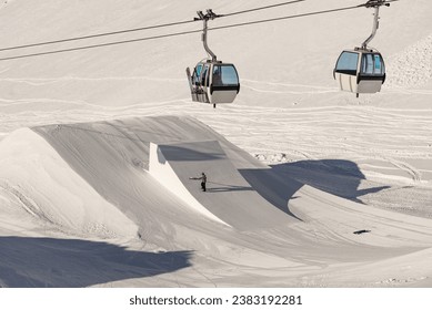 Snowpark Shaper shaping a kicker with a shapetool .Madonna di Madonna di Campiglio and ursus snowpark in Val Rendena dolomites trentino Italy. 