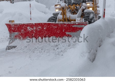 A snowplow clearing the snow from roads.