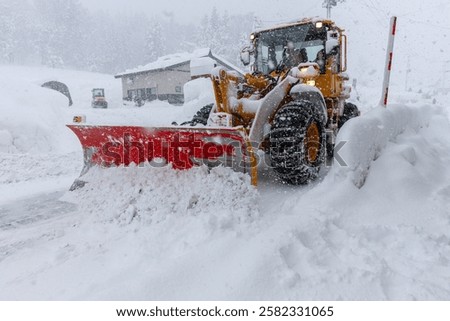 A snowplow clearing the snow from roads.