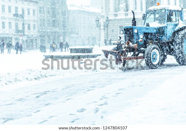 snowplow close\
up cleaning street of snow\
concept