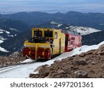 Snowplow cog train climbs to the top of Pike