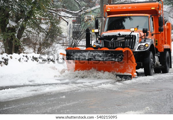 snowplow\
removing snow in the street after\
blizzard