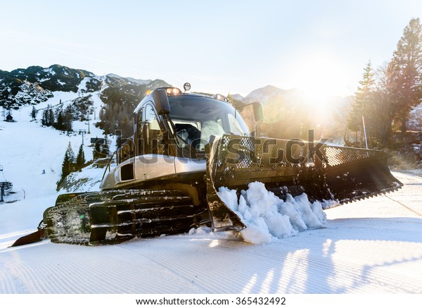 Snowplow Snowcat Ski slopes maintenance on the\
mountains ski resort