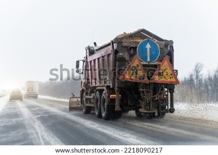 Snowplow truck removing dirty snow from city street or highway after heavy snowfalls. Traffic road situation. Weather forecast for drivers. Seasonal road maintenance. Bad conditions, slippery freeway
