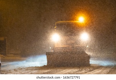 Snowplow Trucks Removing Snow On The Road Street In Blizzard Snowstorm At Night