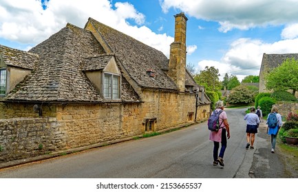 Snowshill, Gloucestershire, UK, May 7th, 2022, Walkers Out For A Hiking Expedition Going Through The Village On A Beautiful Spring Day.