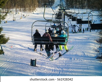 Snowshoe, USA - January 9, 2010: Mountain Ski Lift With People Sitting With Snowboards