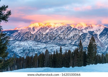 Snowshoeing tour at Purgatory Ski Resort.  Alpenglow at sundown on nearby Grizzly Peak.  