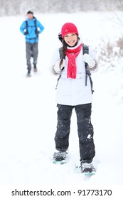 Snowshoeing Winter Hiking. Active Couple On Snowshoes Outdoors In Snow Walking In Natural Park In Canada, Quebec.