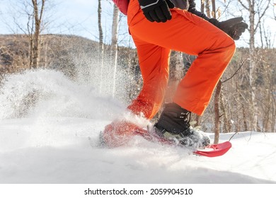 Snowshoes walking in snow. Closeup of legs of man athlete running in white deep powder snow snowshoeing wearing snowshoe boot. - Powered by Shutterstock