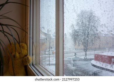 Snowstorm in Sweden, Strong wind city street view through snow covered window, Vasteras, Winter nasty weather in Scandinavia