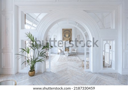 snow-white luxury apartment interior with Egyptian-style decor with light stylish furniture. huge panoramic windows and an archway. minimalism and simplicity with the elegance of modern housing design