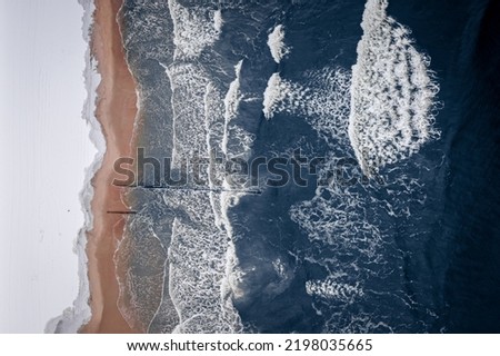 Snowy beach at Baltic sea. Winter tourism in Poland. Aerial view of wildlife in Poland