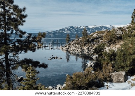 Snowy Beaches of Lake Tahoe, California, during Heavy Snow Storm with Mountain and Forest View behind