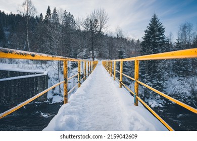 A Snowy Bridge In A Forest