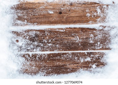 Snowy brown rustic aged wooden background. Christmas wooden textured background with snow. - Powered by Shutterstock