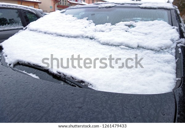 Snowy car in the parking\
lot
