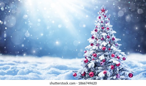 Snowy Christmas Tree With Red Balls In A Abstract Defocused Landscape
