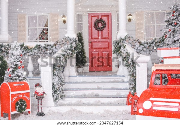 Snowy courtyard with\
Christmas porch, veranda, wreath, Christmas tree, red car, gnome,\
letterbox for Santa Claus, lanterns, garland. Merry Christmas and\
Happy New Year