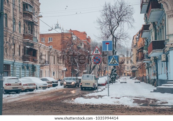 Snowy day, street\
view of the city in\
Europe.