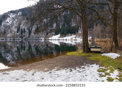 The snowy December landscape at Afritzer See Lake in Carinthia, Austria. Located in the Gegendtal Valley, it is in the Nock Mountains of the Gurktal Alps