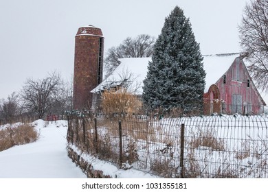 Snowy Farm Scene In Iowa With Red Barn