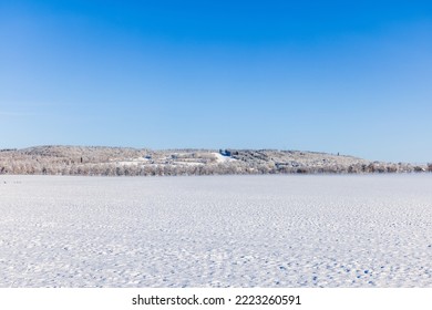 Snowy fields with a hill on a sunny winter day - Powered by Shutterstock