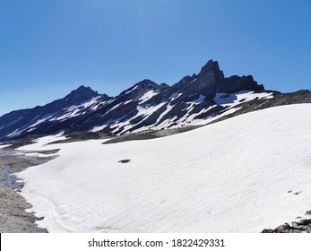 Snowy flat area in high altitude in Swiss Alps near Forclaz pass on a sunny day