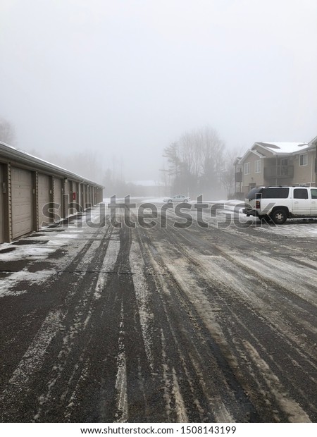 Snowy foggy parking lot in\
Wisconsin