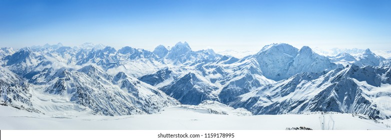 Snowy Greater Caucasus ridge with the Mt. Ushba at winter sunny day. View from Pastuchova kliffs at Elbrus ski slope, Kabardino-Balkaria, Russia