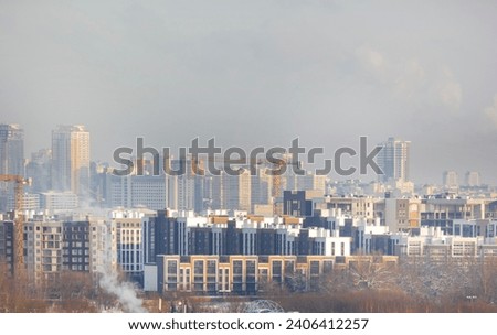 Snowy haze in Europe, skyline with urban new buildings. Selective focus