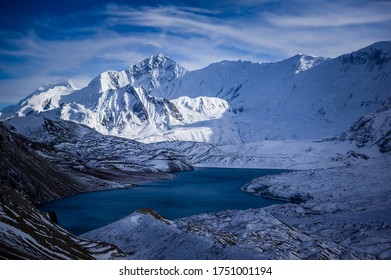 Snowy ice ridge and lake Tilicho with Khangsar Kang mountain in the background