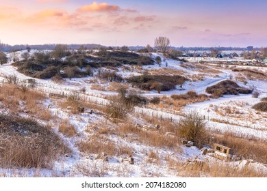 Snowy landscape with hills and meadows under a blue sky in Winter season. Buytenpark Zoetermeer, the Netherlands
