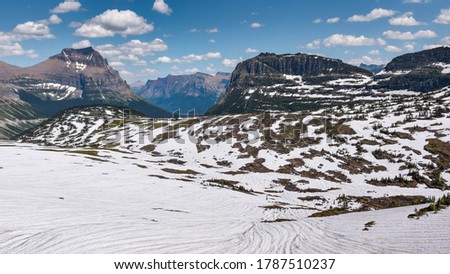 Snowy Logan pass trail in Glacier National Park on a Sunny Day 