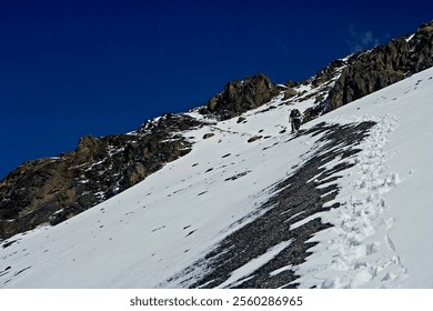 Snowy Mountain Hike in Bolivia
Two hikers ascend a snow-covered slope in Bolivia, surrounded by rugged terrain and a clear blue sky, showcasing the country's diverse and challenging landscapes. - Powered by Shutterstock