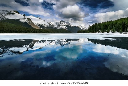 Snowy Mountain Lake Reflection with Dramatic Clouds