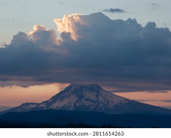 Snowy Mountain Peak Under Dramatic Sunset Clouds