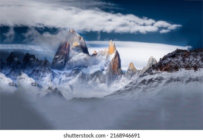 Snowy mountain peaks of the winter mountains. Mountain peaks on snow landscape. Beautiful high mountain peaks in snow. Snowy mountain peaks in clouds