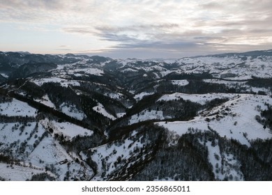Snowy mountain range captured from above with a drone Aerial Drone Moeciu Brasov - Powered by Shutterstock