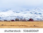 A snowy mountain range stands high over a ranch in southwestern Montana.