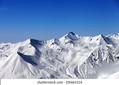 Snowy mountains and blue sky. Caucasus Mountains, Georgia, region Gudauri.