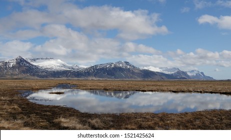 Snowy mountains landscape with reflection in a lake