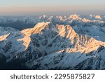 Snowy mountains at sunrise. Beautiful landscape with snowy rocks. View from the top of Mount Elbrus